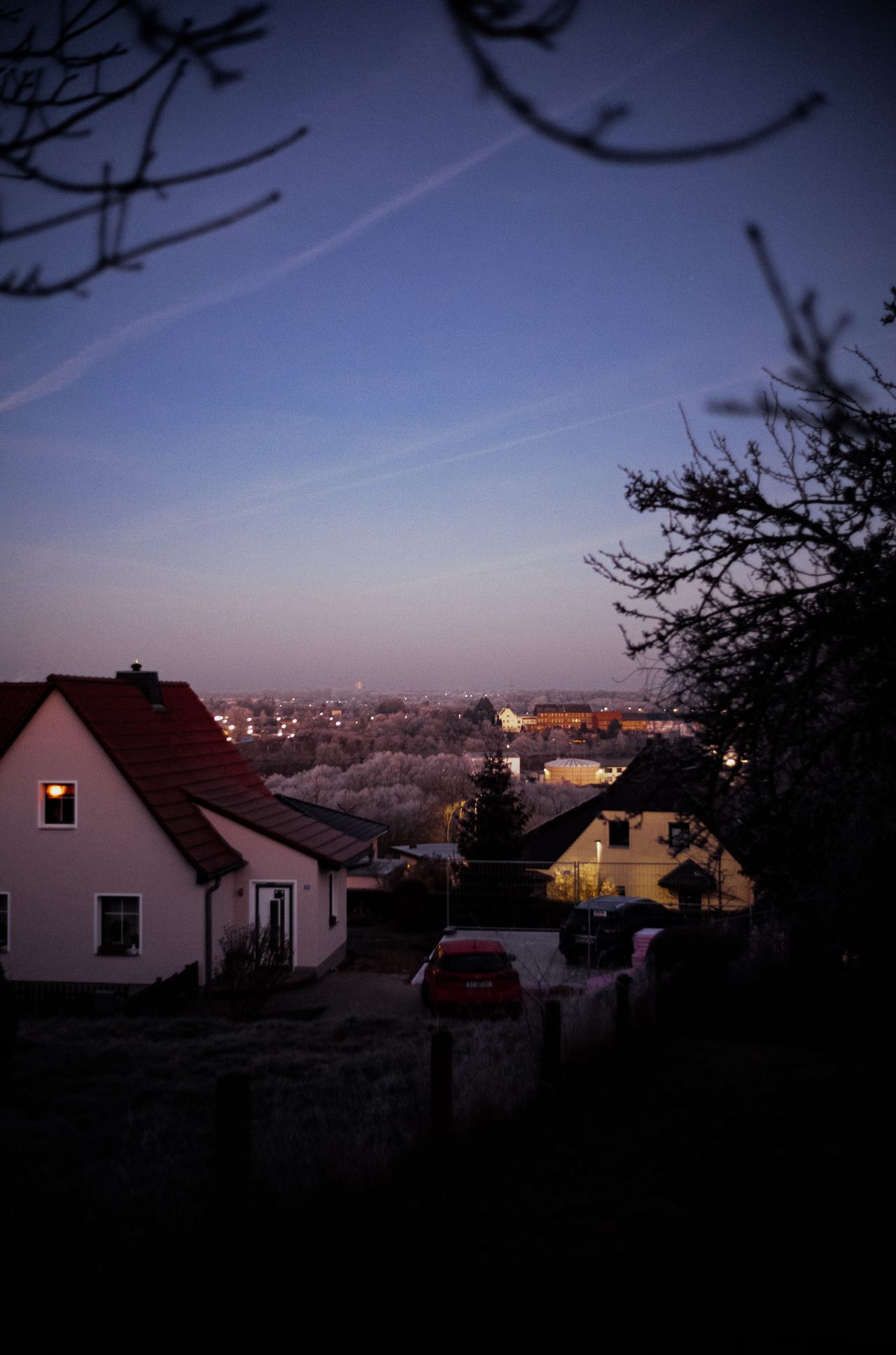 Homes on a frosty city edge during blue hour
