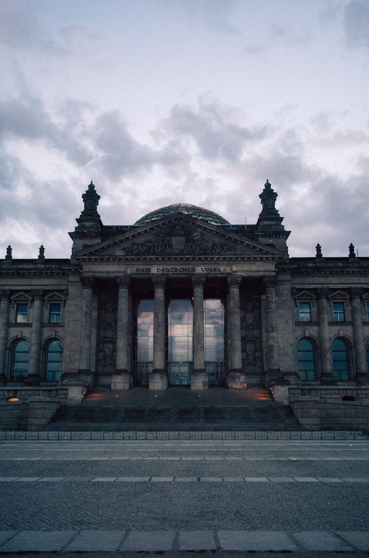 Reichstag building beneath a dense cloudy sky