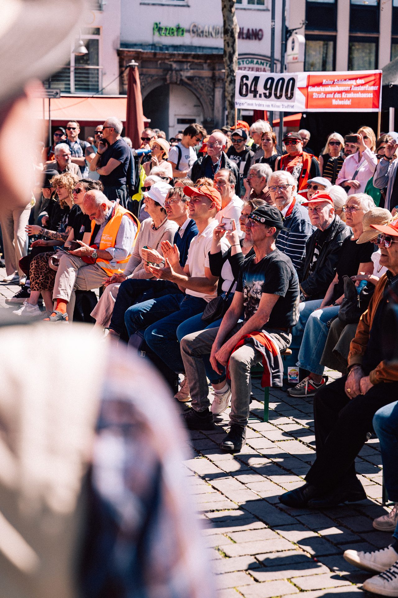 Seated crowd watching an outdoor rally