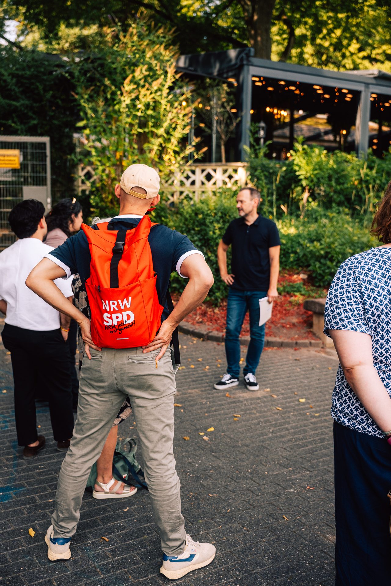 Participant with a red SPD backpack during an outdoor tour